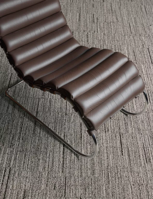 Interface Comes Around plank carpet tile in close-up with MR Lounge Chair