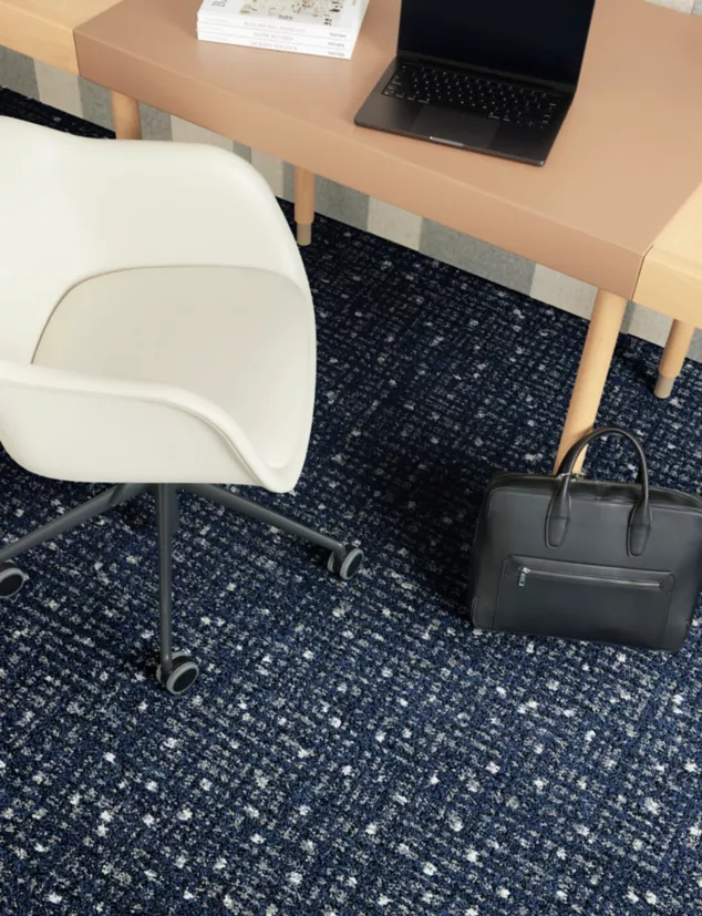 Interface Positive Spin carpet tile in close-up shot of workplace desk and chair